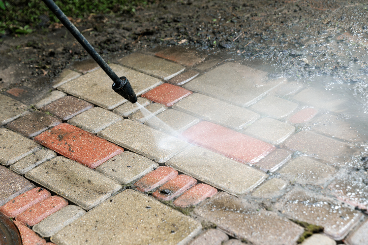 someone power washing a patio