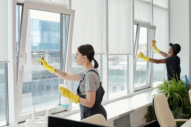 window cleaning workers cleaning a window in an office